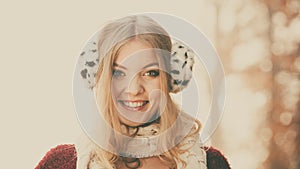 Portrait of pretty smiling woman in fur earmuffs.