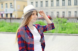 Portrait of pretty smiling woman wearing a summer straw hat