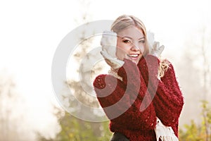 Portrait of pretty smiling woman in white earmuffs.