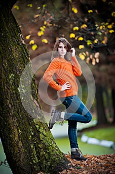 Portrait of pretty teen girl in autumn park