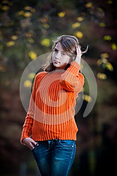 Portrait of pretty teen girl in autumn park