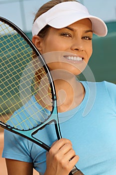 Portrait of pretty tennis player smiling