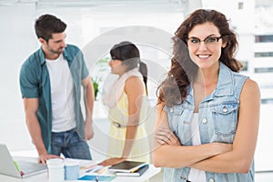 Portrait of pretty woman in front of colleagues