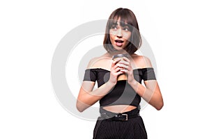 Portrait of a pretty woman holding takeaway coffee cup isolated over white background