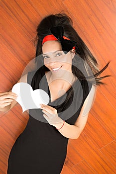 Portrait pretty woman holding a white paper heart