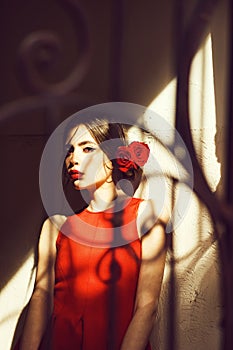 Portrait of pretty woman with red lips and rose flower