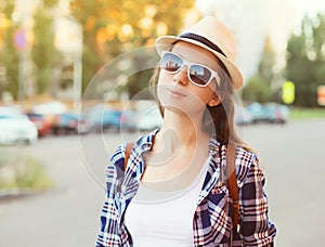 Portrait of pretty woman wearing a sunglasses and straw hat