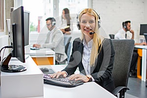 Portrait of pretty young blonde woman dispatcher working in call center