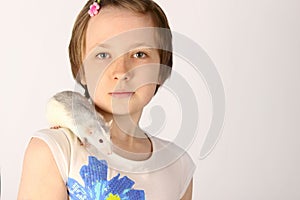 Portrait of a pretty young girl with her pet rat.