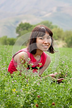 Portrait of pretty young lady on a meadow