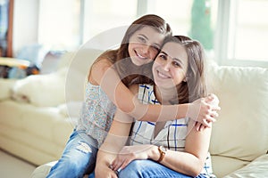 Portrait of pretty young mother with her tennager daughter