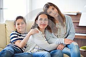 Portrait of pretty young mother with her tennager daughter and s