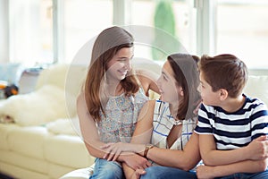 Portrait of pretty young mother with her tennager daughter and s