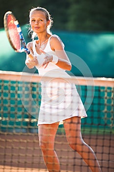 Portrait of a pretty young tennis player at play