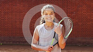 Portrait of pretty young tennis playgirl standing with racket.