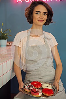 Portrait of a pretty young waitress in apron