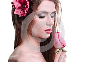 Portrait of a pretty young woman with a delicate rose