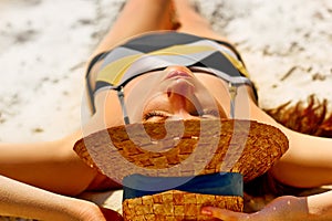 Portrait of a pretty young woman having sunbath on the beach