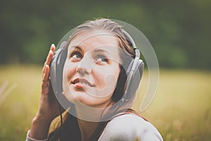 Portrait of a pretty young woman listening to music