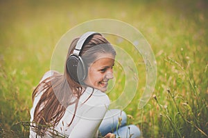 Portrait of a pretty young woman listening to music