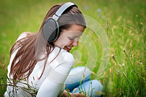 Portrait of a pretty young woman listening to music