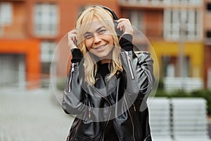 Portrait of pretty young woman listening to music with wireless headphones