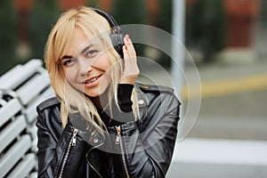 Portrait of pretty young woman listening to music with wireless headphones