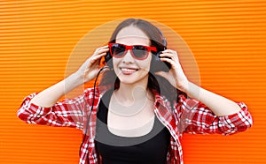 Portrait of pretty young woman listens to music in headphones