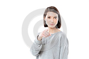 Portrait of a pretty young woman pointing finger at camera