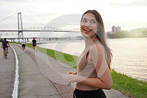Portrait of pretty young woman relaxing at crepuscle on promenade Beira-mar Norte in Florianopolis, Santa Catarina, Brazil photo