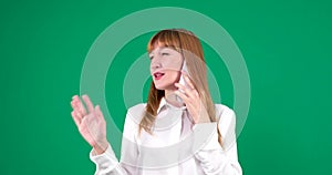 Portrait of pretty young woman is talking for mobile phone. Green screen talking phone woman green background