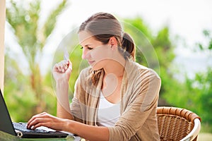 Portrait of a pretty young woman working on her computer