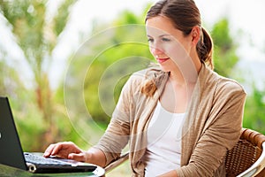 Portrait of a pretty young woman working on her computer