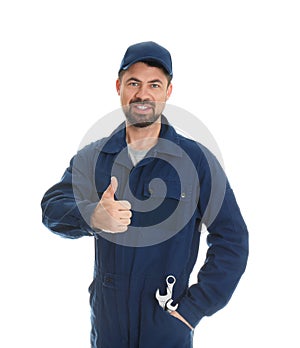 Portrait of professional auto mechanic with wrenches on white background