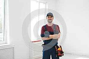 Portrait of professional construction worker with tool belt