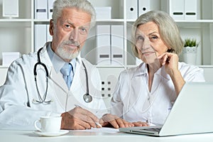 Portrait of professional doctors working in cabinet