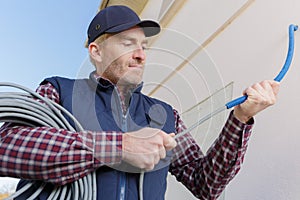 portrait professional electrician worker using pipes