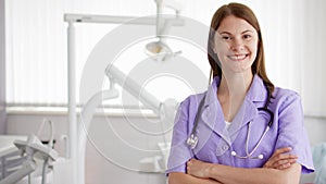Portrait of professional female doctor standing in hospital room. Woman physician with stethoscope