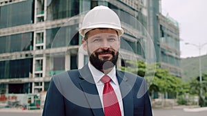 Portrait of Professional Heavy Industry Engineer Worker Wearing Safety Uniform, Goggles and Hard Hat Smiling. In the