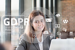 Portrait of an professional investment advisor businesswoman sitting in front of laptop at her desk while looking at camera.