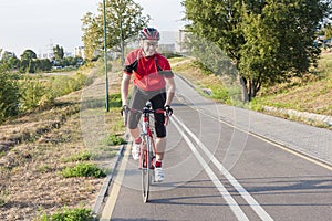 Portrait of Professional Male Cyclist Doing Uphill