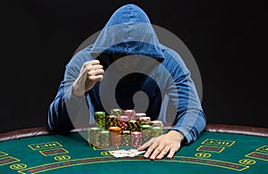 Portrait of a professional poker player sitting at pokers table