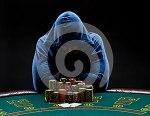 Portrait of a professional poker player sitting at pokers table