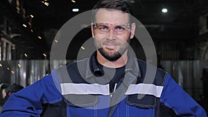 Portrait of professional smiling heavy industry worker engineer man in factory