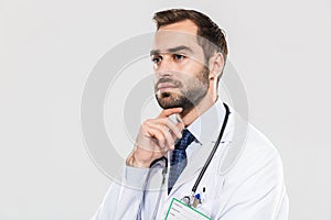 Portrait of professional young medical doctor with stethoscope looking aside and touching his chin