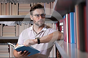 Portrait of professor with book in classroom. Handsome professor in library. Teachers Day. Good professor. Man professor