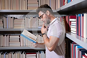 Portrait of professor with book in classroom. Handsome professor in library. Teachers Day. Good professor. Man professor