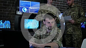 Portrait proficient soldier, in military base, working for laptop,