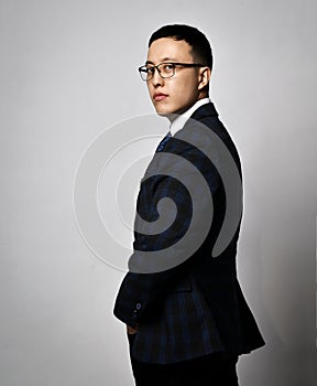 Portrait profile of asian businessman expert analyst in official suit, tie and glasses standing back leaving and turned