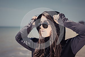 Portrait in profile of a teenage girl in sunglasses